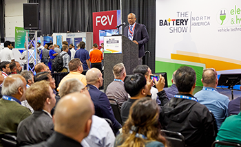 A man delivers a presentation to a large audience gathered at  Battery Tech Theater